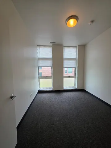 a view of an empty room with a fireplace