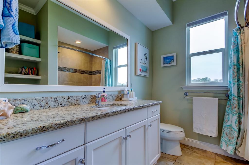 6367 Foxbrook Trail Parrish, FL 34219 - Photo 14 of 25 a bathroom with a granite countertop sink a toilet and a mirror