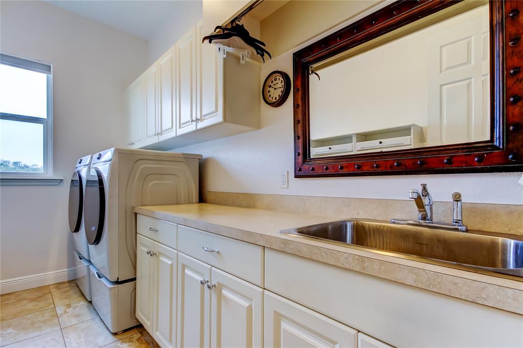 6367 Foxbrook Trail Parrish, FL 34219 - Photo 15 of 25 a bathroom with a sink a mirror and cabinets