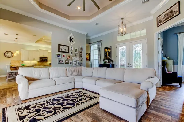 a living room with furniture and a view of kitchen