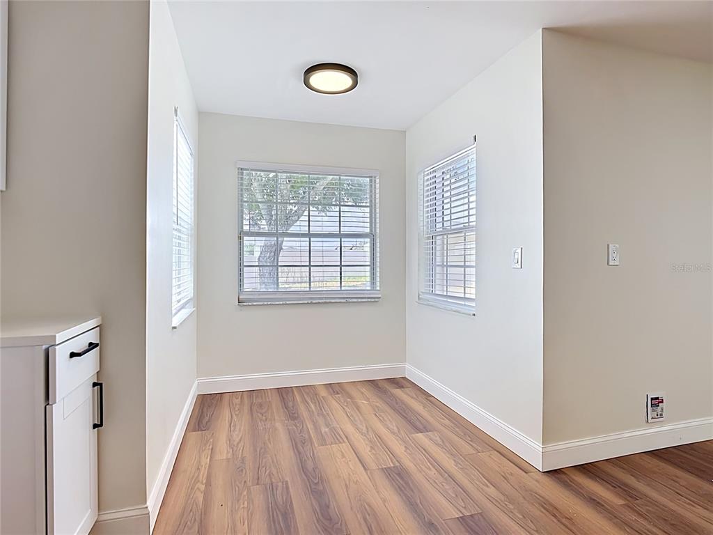 7925 Lake Mabel Loop Road Lake Wales, FL 33898 - Photo 21 of 97 an empty room with wooden floor and windows