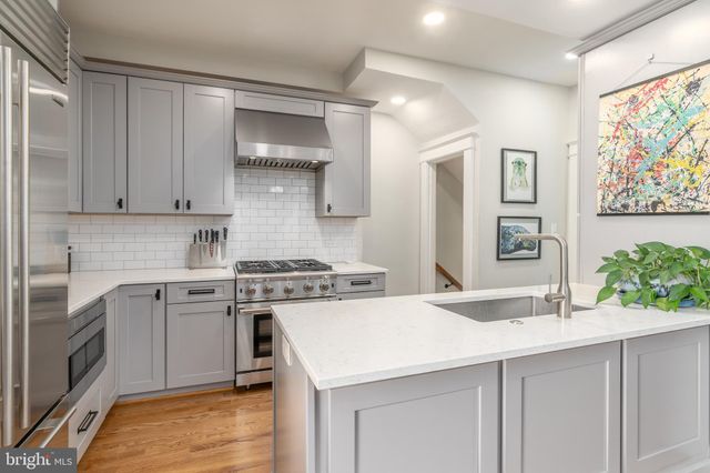 a kitchen with a stove a sink and a refrigerator