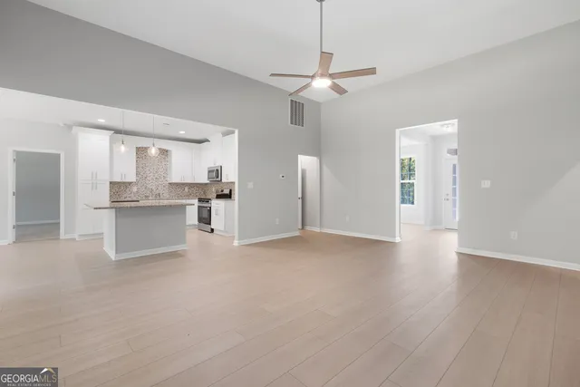 a kitchen with stainless steel appliances granite countertop a sink and a stove