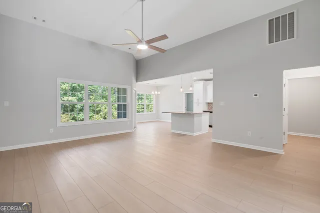 a kitchen with granite countertop white cabinets and stainless steel appliances