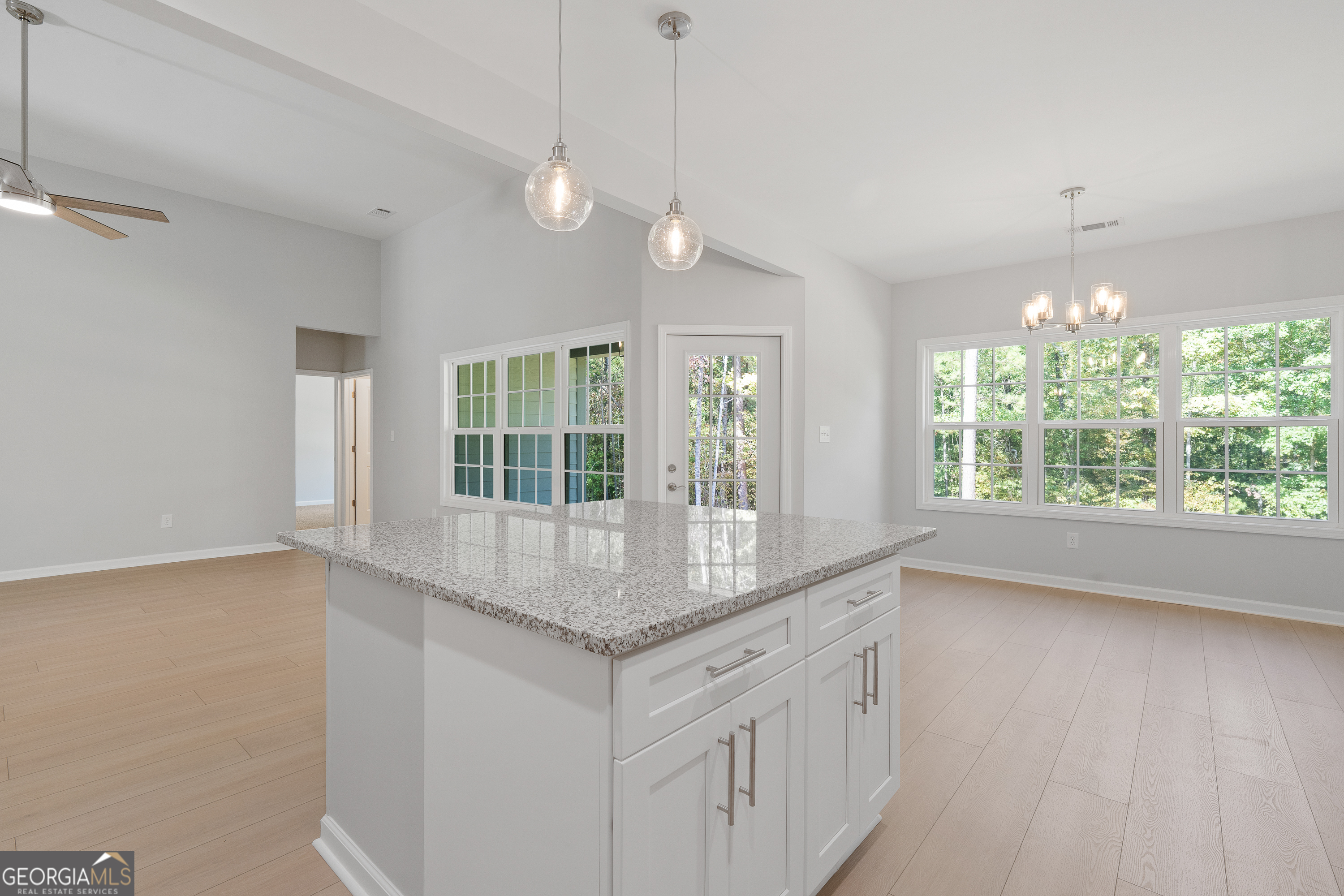 4477 Rivercliff Way Gray, GA 31032 - Photo 19 of 62 a kitchen with stainless steel appliances granite countertop a stove a sink and a large window