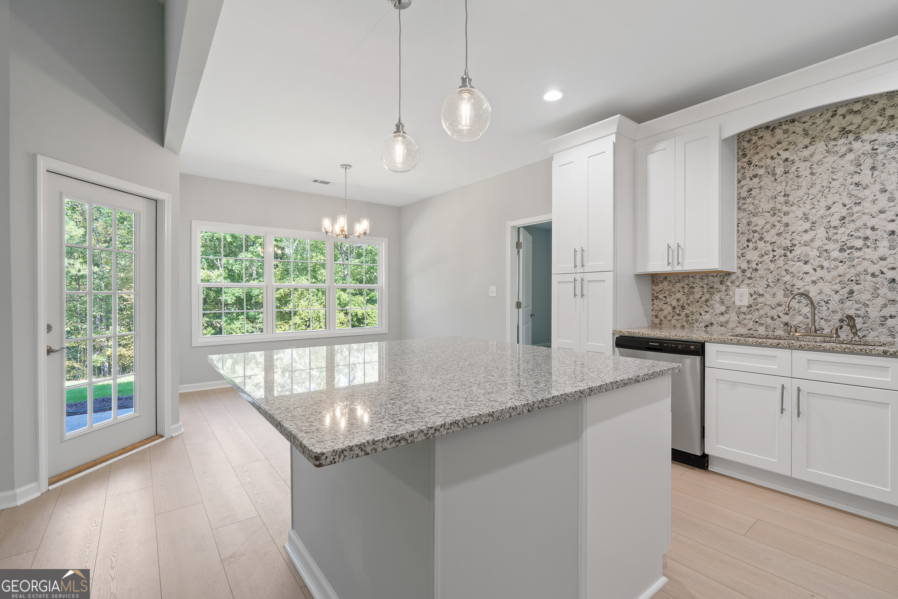 4477 Rivercliff Way Gray, GA 31032 - Photo 20 of 62 a kitchen with stainless steel appliances granite countertop a stove a sink and a granite counter tops with white cabinets