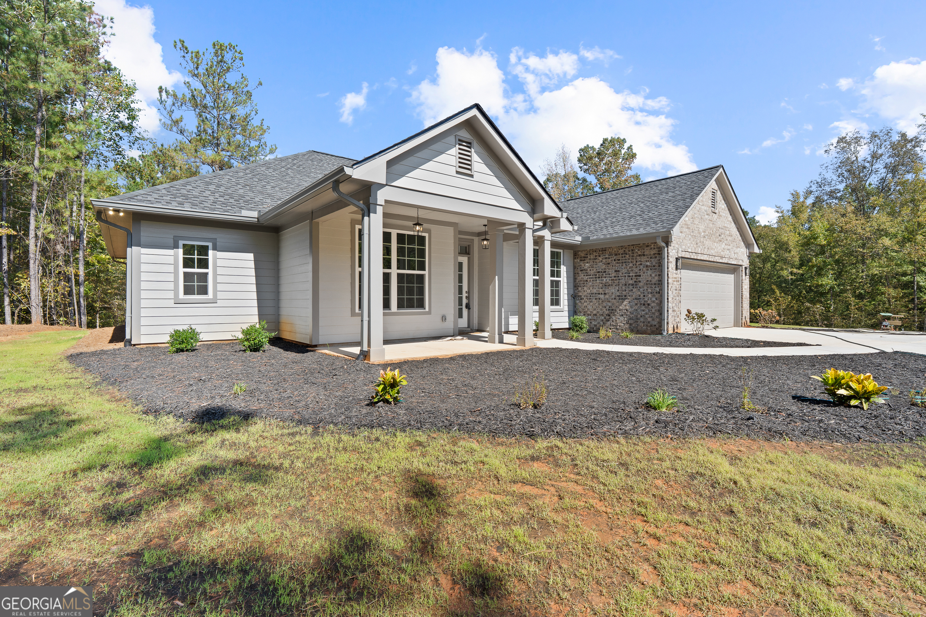 4477 Rivercliff Way Gray, GA 31032 - Photo 2 of 62 a front view of a house with a yard and potted plants