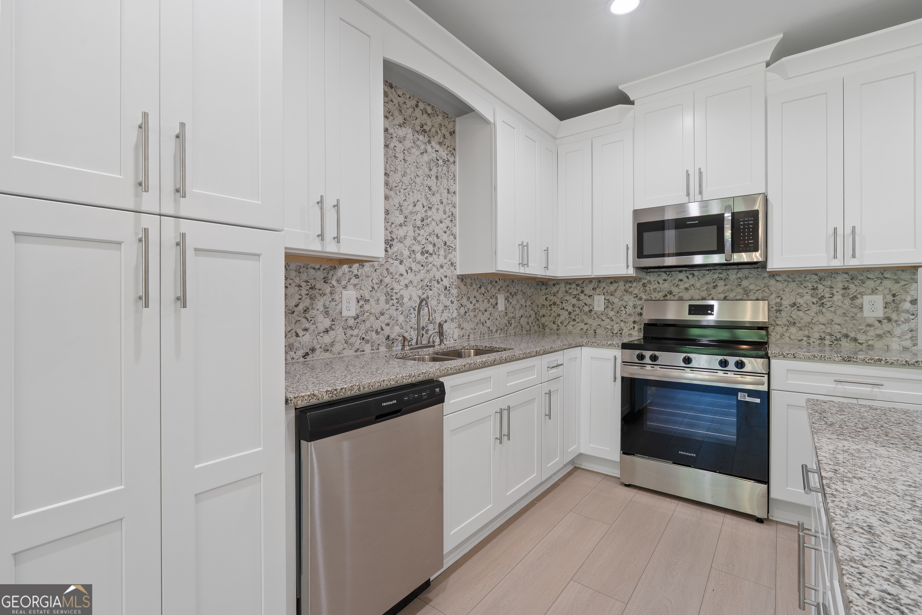 4477 Rivercliff Way Gray, GA 31032 - Photo 23 of 62 a kitchen with stainless steel appliances granite countertop a stove and a microwave
