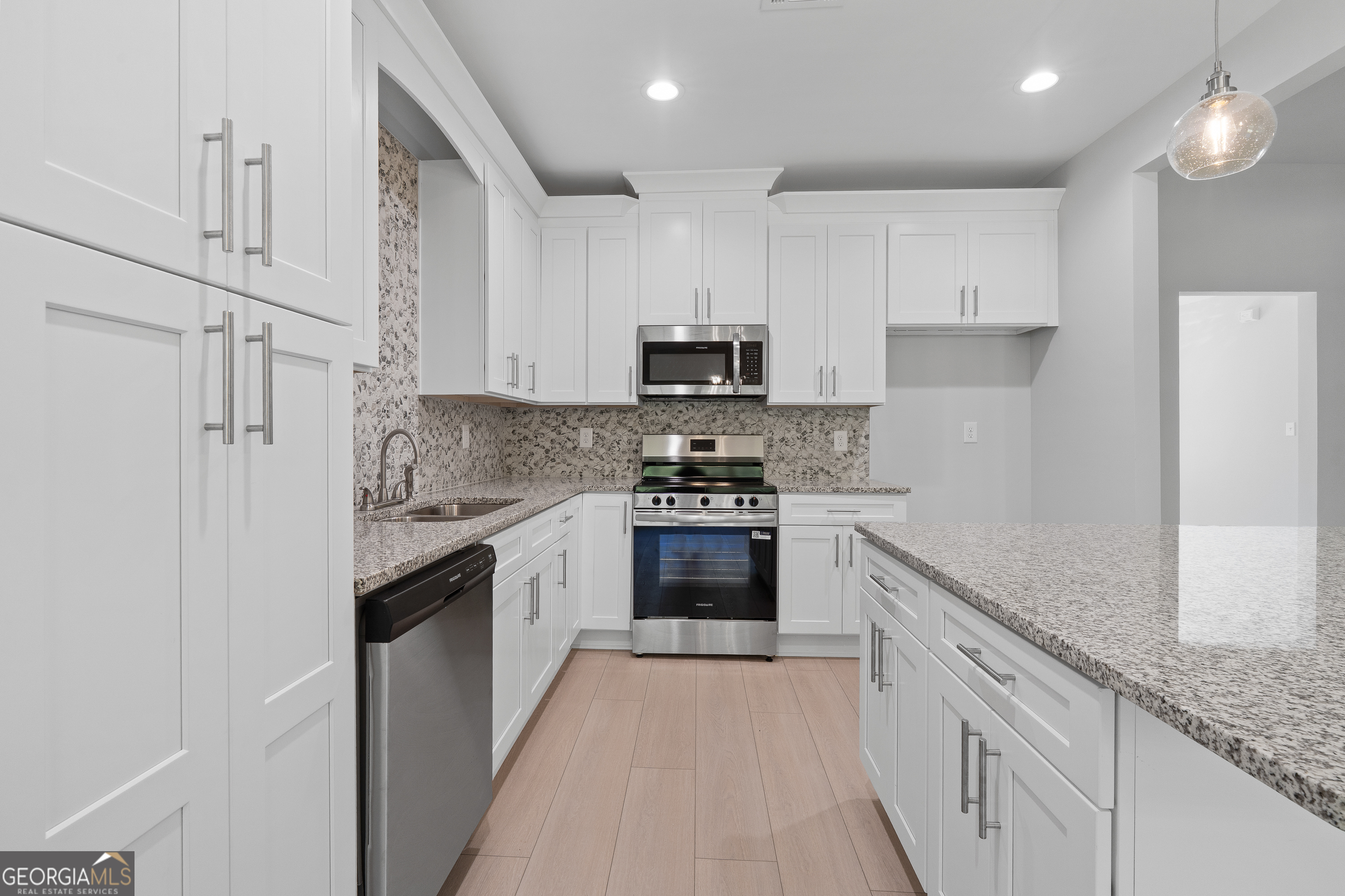 4477 Rivercliff Way Gray, GA 31032 - Photo 24 of 62 a kitchen with granite countertop white cabinets and stainless steel appliances
