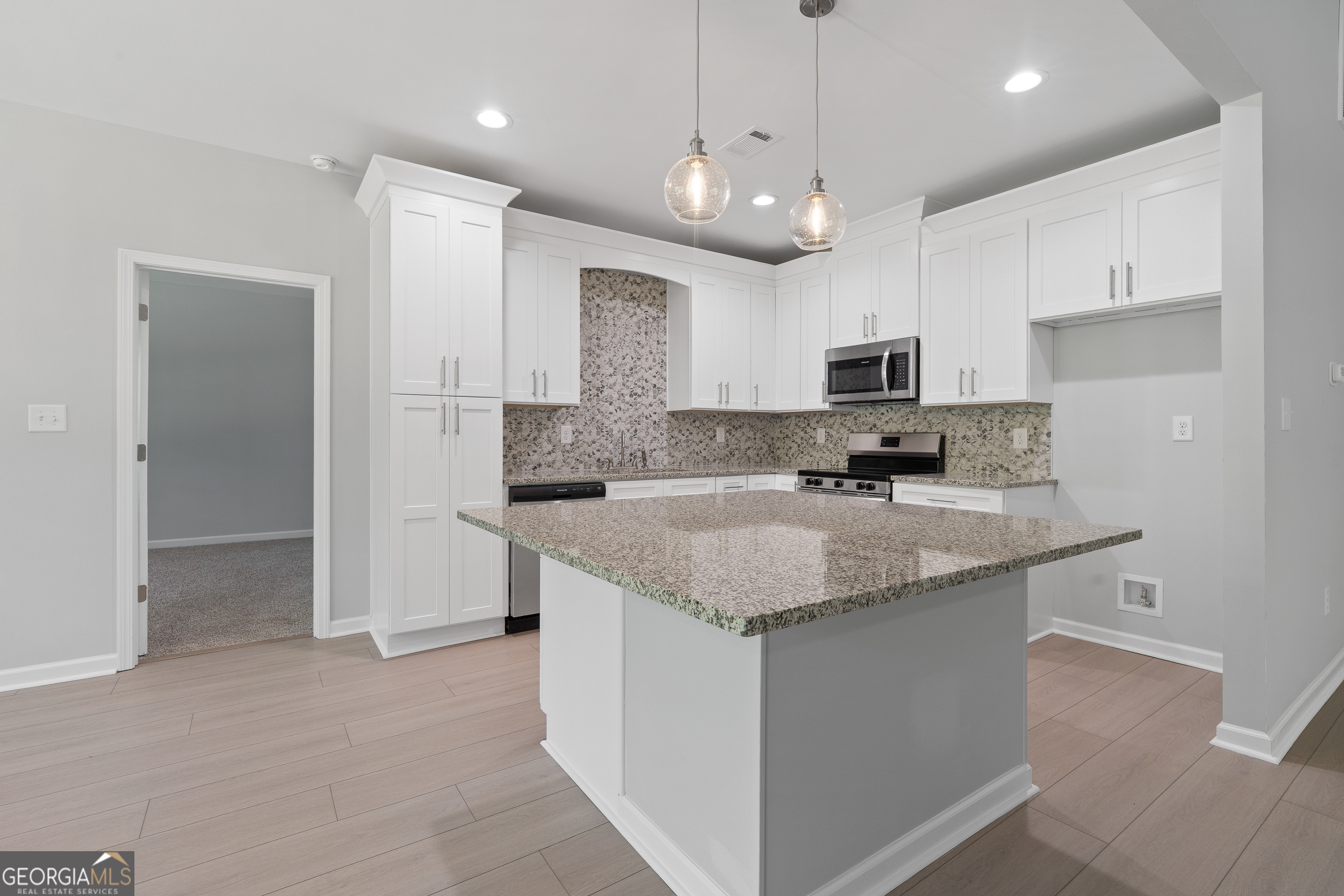 4477 Rivercliff Way Gray, GA 31032 - Photo 26 of 62 a kitchen with stainless steel appliances granite countertop a sink stove and refrigerator