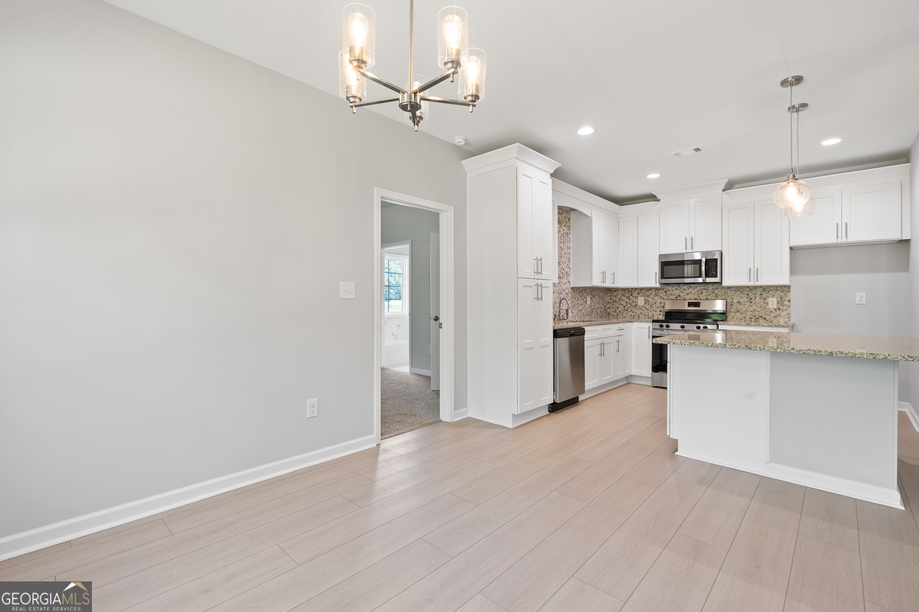 4477 Rivercliff Way Gray, GA 31032 - Photo 27 of 62 a view of kitchen with granite countertop cabinets and refrigerator