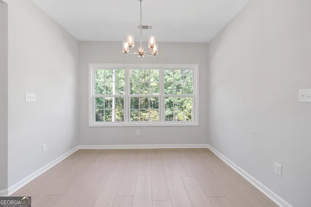 a bathroom with a bathtub and next to a window