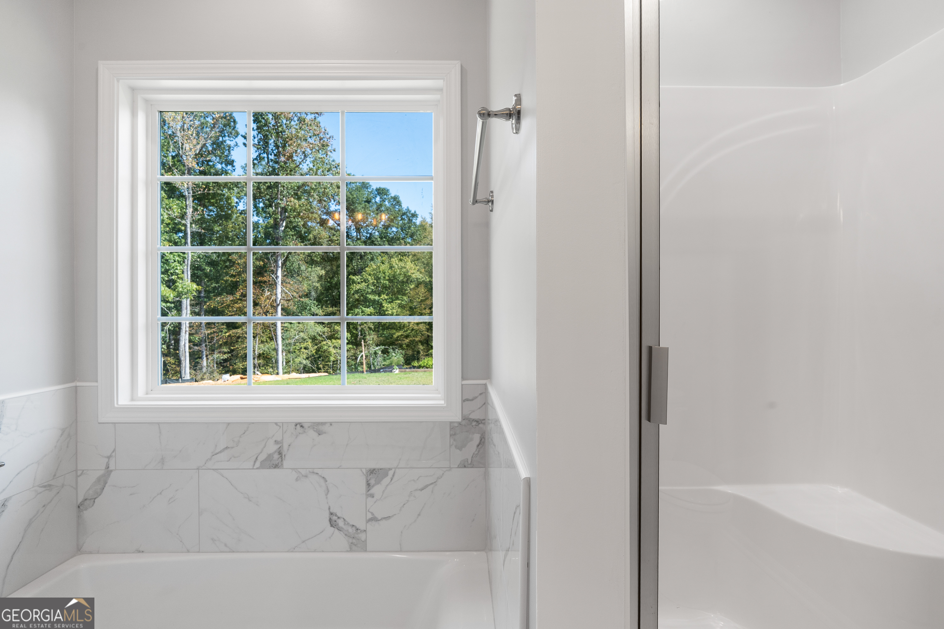 4477 Rivercliff Way Gray, GA 31032 - Photo 37 of 62 a bathroom with a bathtub and a shower