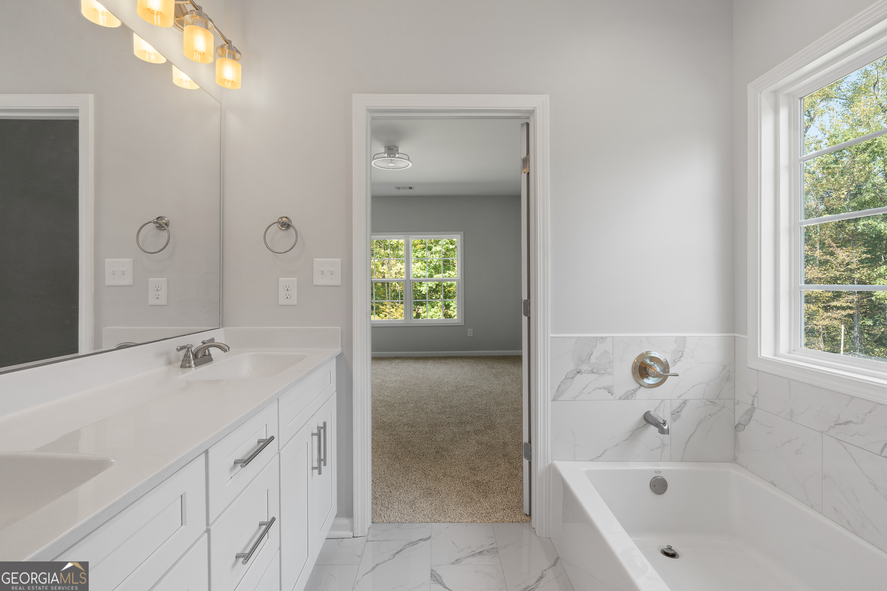 4477 Rivercliff Way Gray, GA 31032 - Photo 39 of 62 a bathroom with a tub sink and mirror