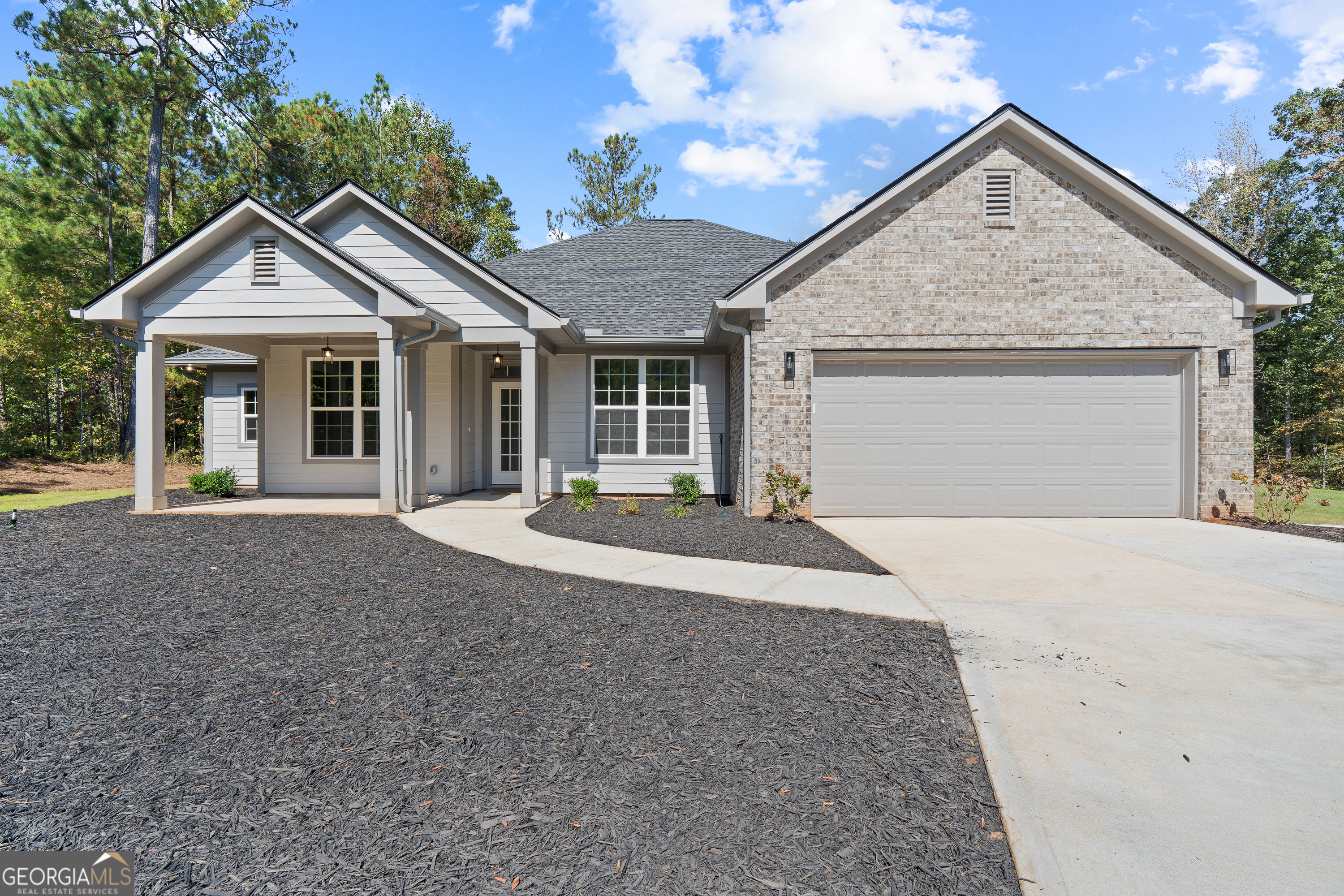 4477 Rivercliff Way Gray, GA 31032 - Photo 4 of 62 a front view of a house with a yard and garage