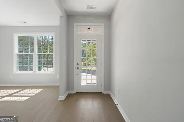 wooden floor in an empty room with a window