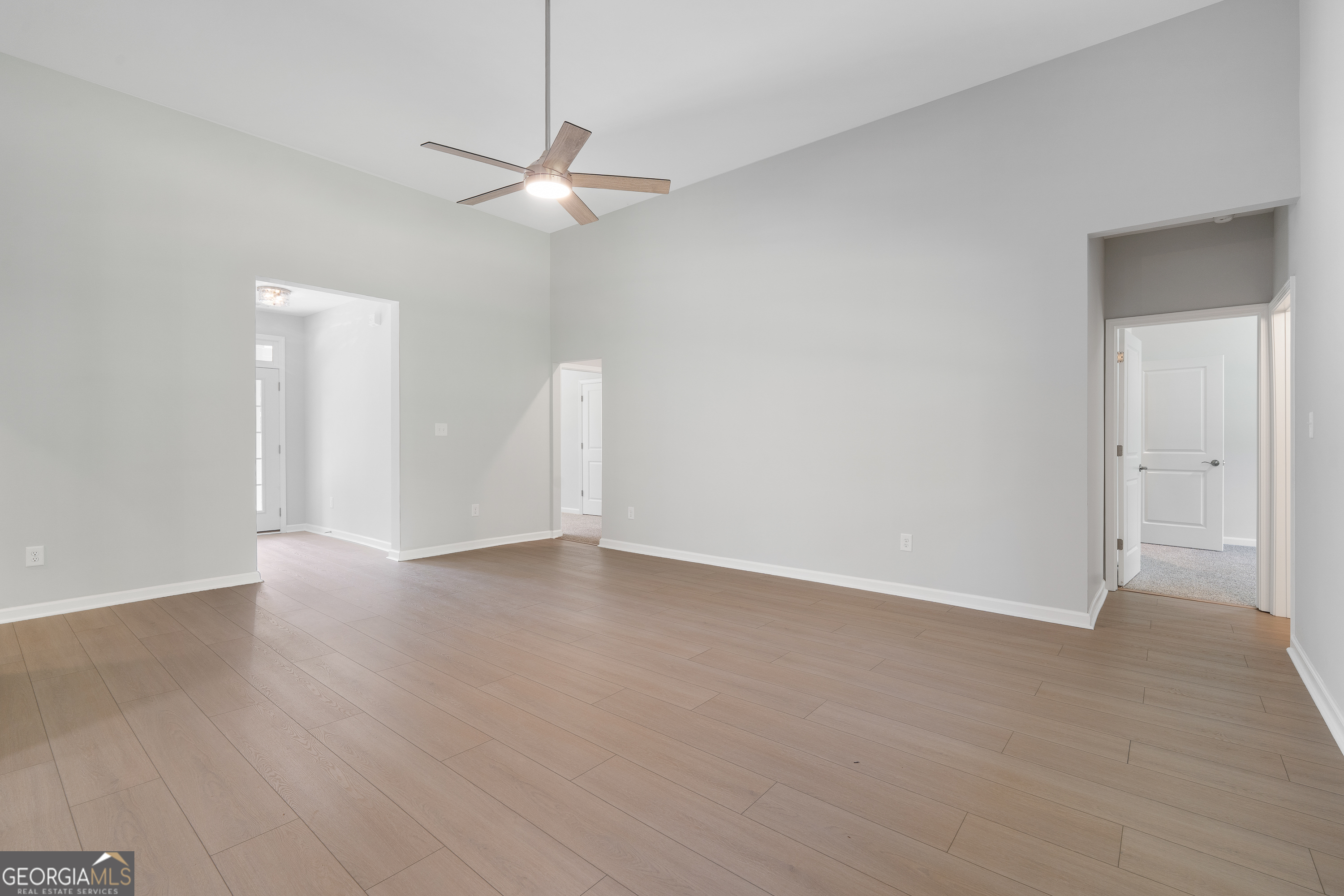4477 Rivercliff Way Gray, GA 31032 - Photo 10 of 62 an empty room with wooden floor and ceiling fan