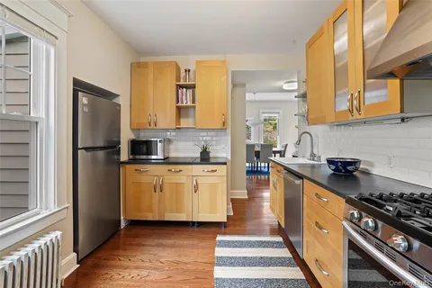 a kitchen with stainless steel appliances granite countertop a stove a sink and a refrigerator