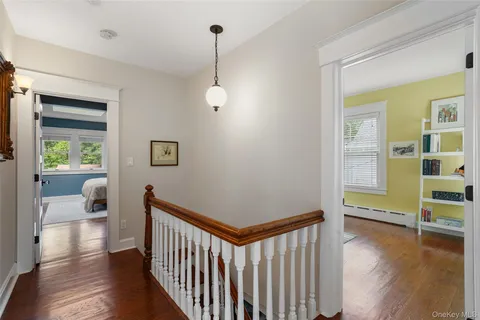 a view of a room with wooden floor and windows