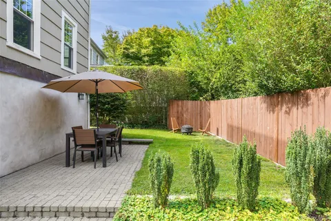 a view of backyard with seating and green space