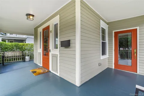 a backyard of a house with wooden floor and fence