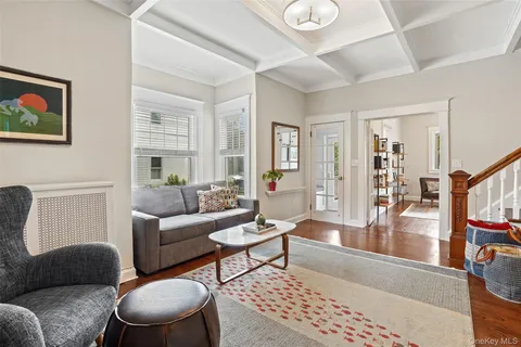 a living room with furniture a rug and a window