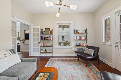 a living room with furniture and a book shelf