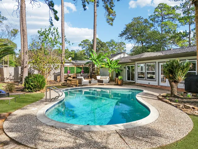 a view of a house with swimming pool and sitting area