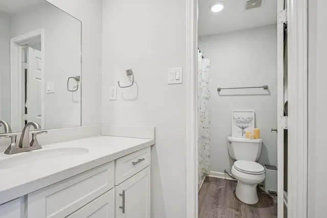 a bathroom with a toilet a sink and a mirror