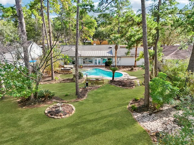 a view of a backyard with lawn chairs and a fire pit