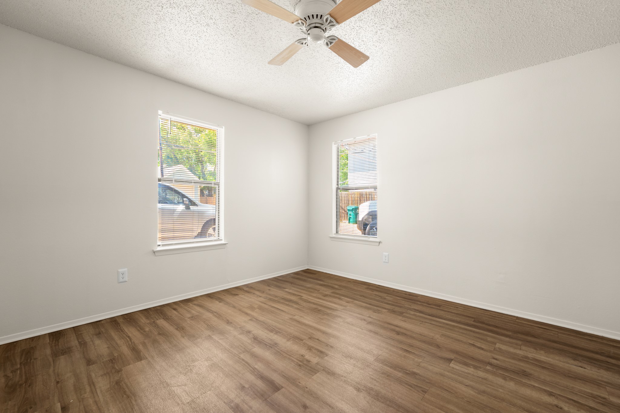 3506 Speedway, Unit 104 Austin, TX 78705 - Photo 1 of 10 a view of an empty room with a window and wooden floor
