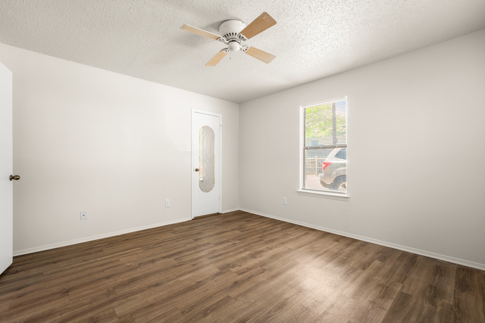 3506 Speedway, Unit 104 Austin, TX 78705 - Photo 2 of 10 wooden floor in an empty room with a window