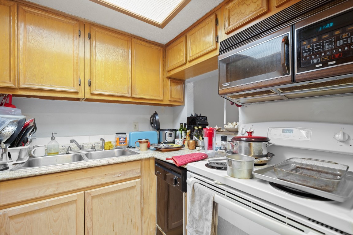 3506 Speedway, Unit 104 Austin, TX 78705 - Photo 4 of 9 Kitchen with black appliances, light countertops, and light brown cabinetry