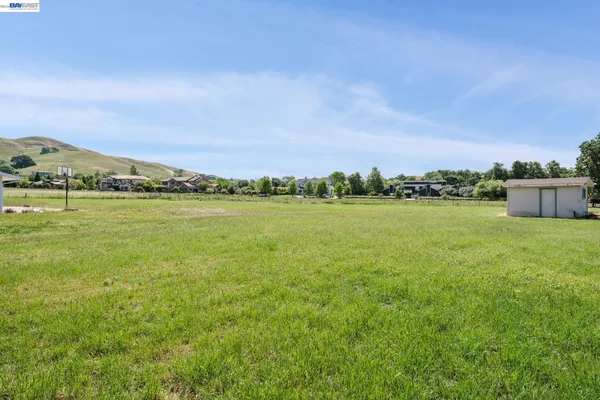 a view of a green field with clear sky