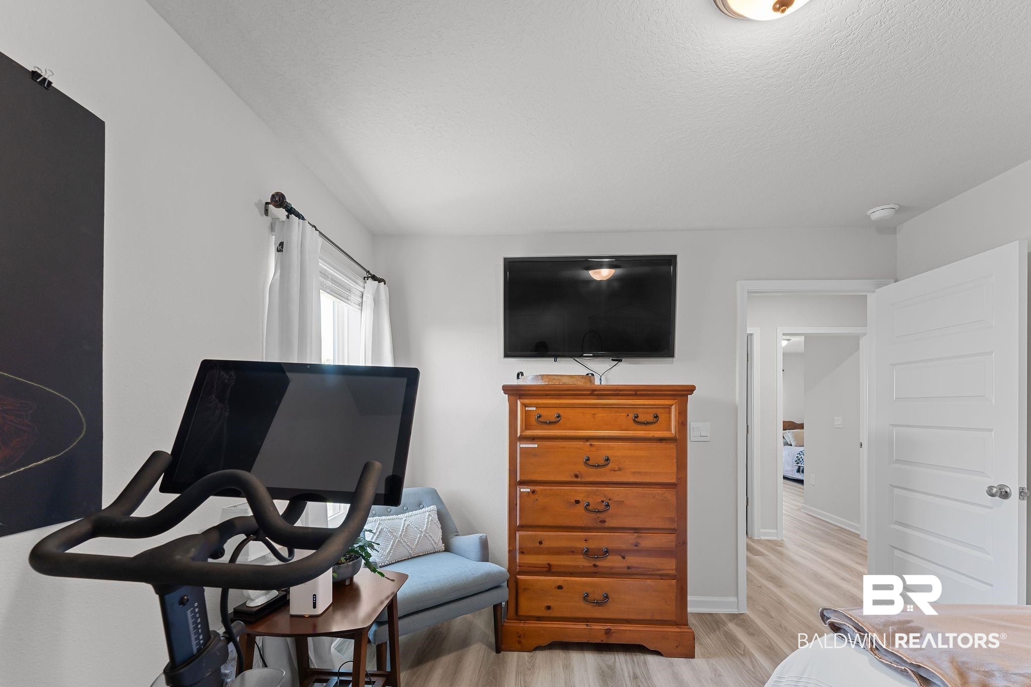24337 Ringneck Loop Elberta, AL 36530 - Photo 20 of 34 Bedroom with light wood finished floors and a textured ceiling