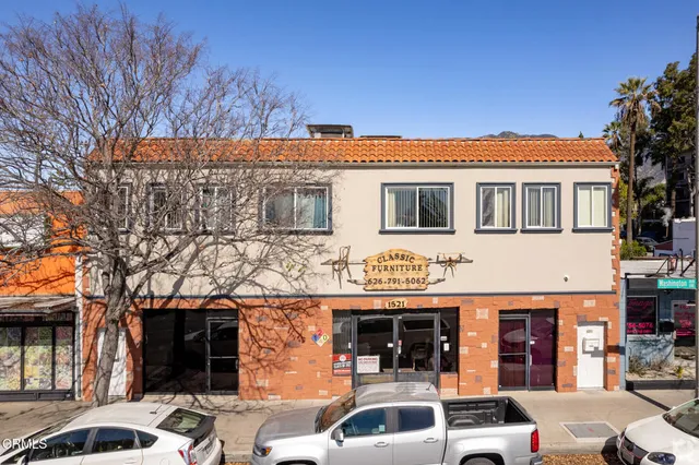 a front view of a building with parking space