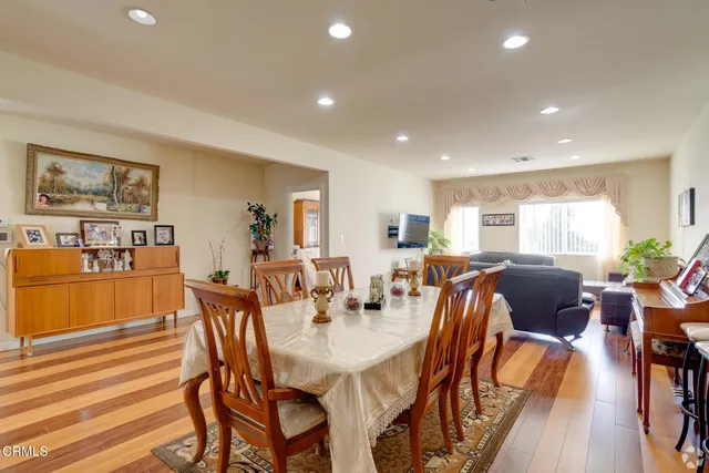 a view of a dining room with furniture window and wooden floor