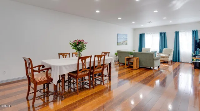 a view of a dining room with furniture and wooden floor