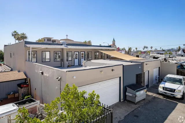 a view of a house with roof deck front of house