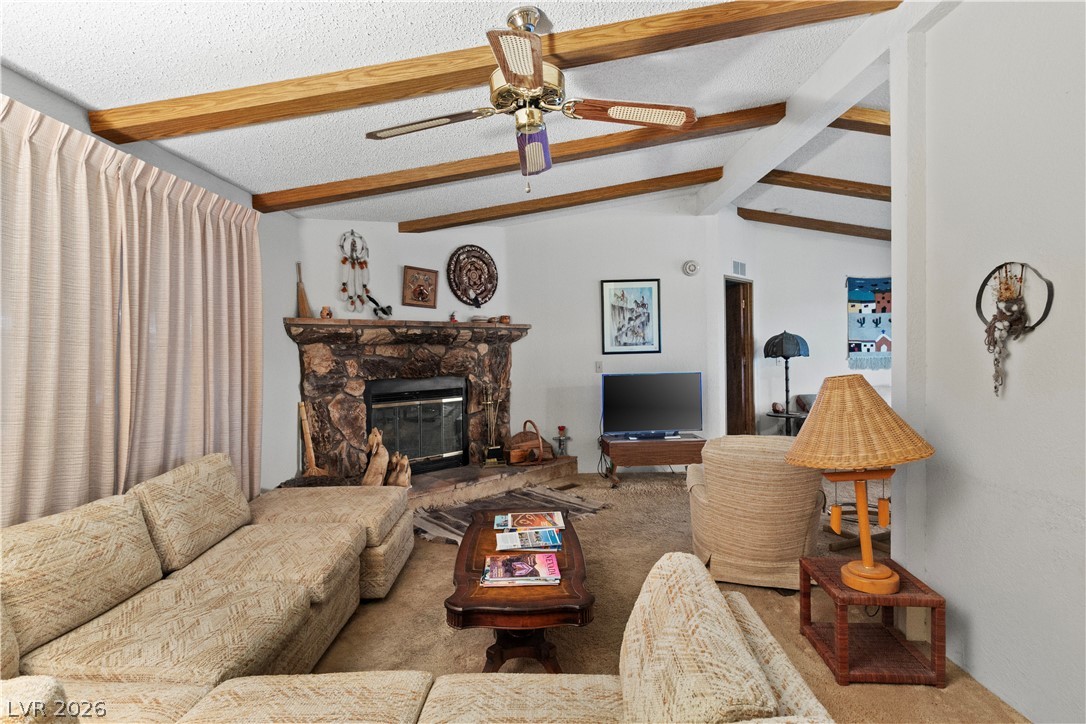1609 Cajon Court Laughlin, NV 89029 - Photo 6 of 69 Living area with carpet flooring, ceiling fan, a fireplace, and beam ceiling