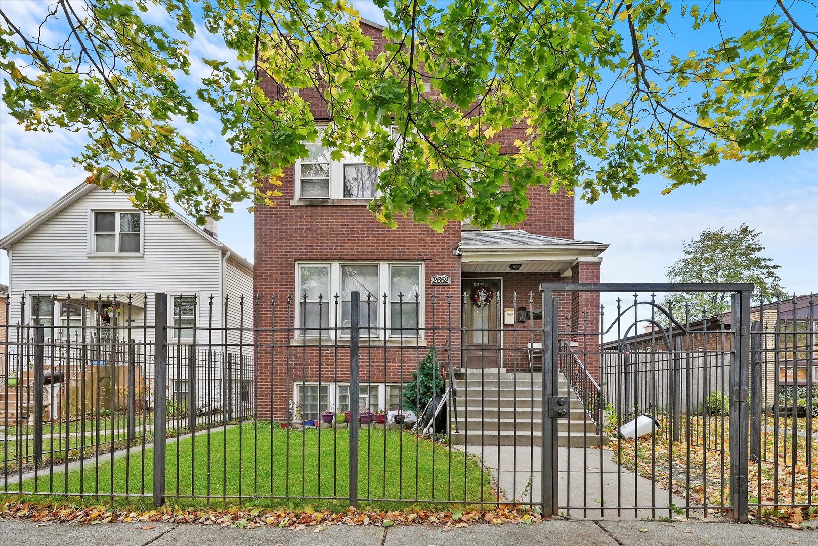 2652 North Meade Avenue Chicago, IL 60639 - Photo 1 of 25 a front view of a house with a garden