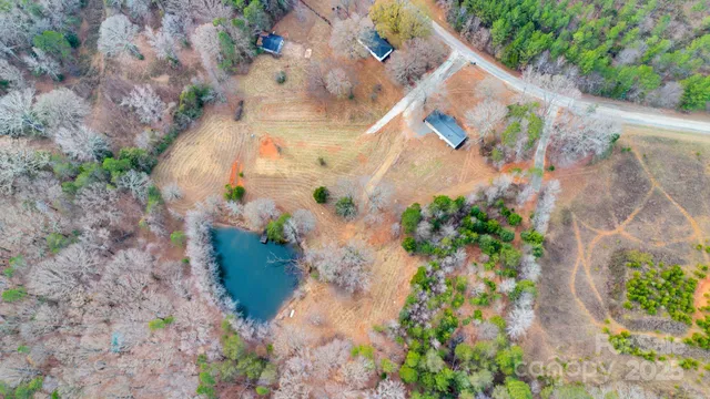 an aerial view of a house with a yard and trees