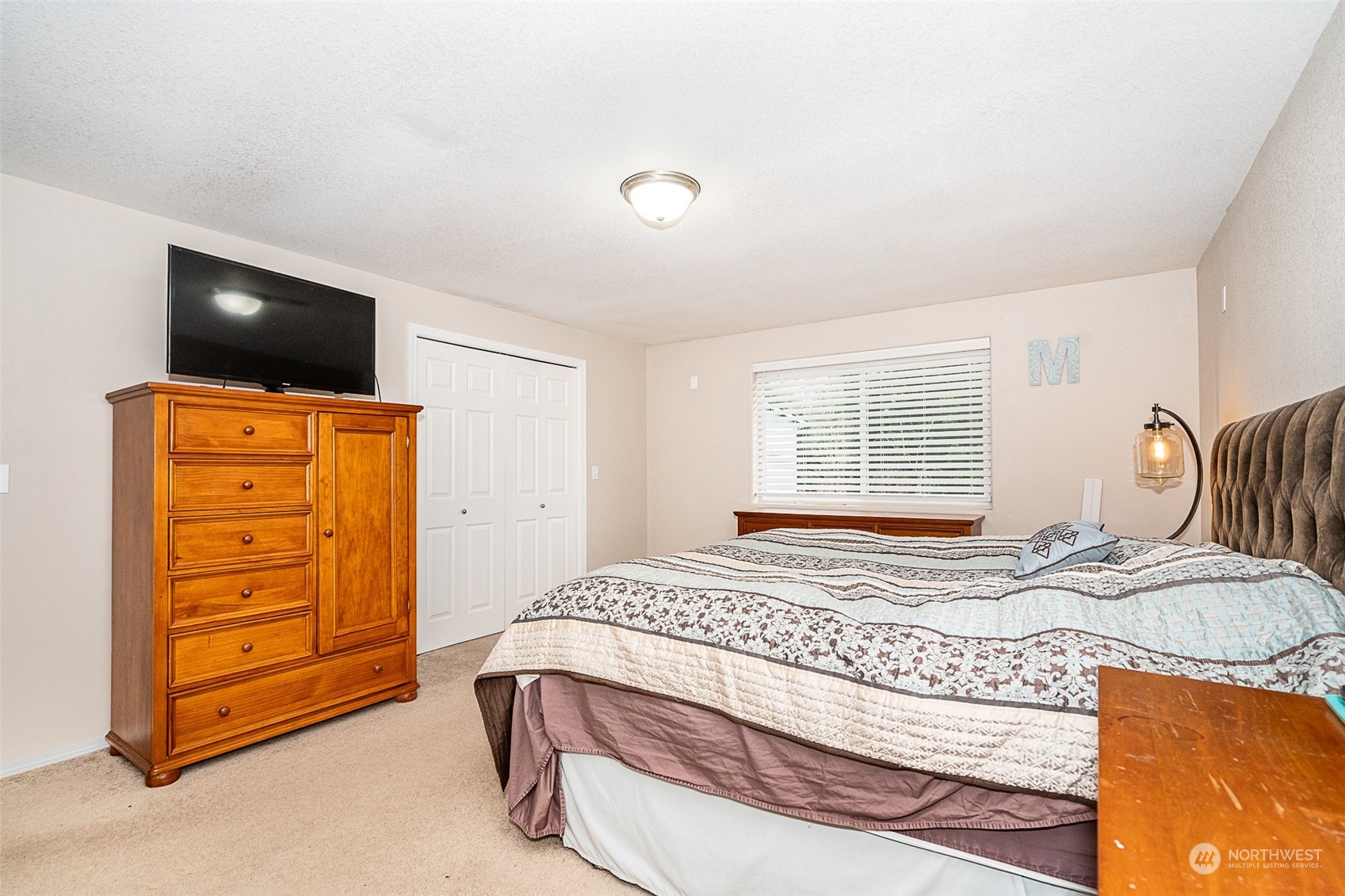 330-38 Brockway Road Chehalis, WA 98532 - Photo 17 of 40 a bedroom with a bed and a flat screen tv