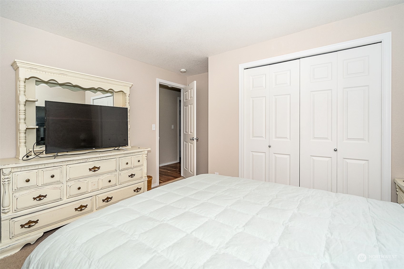 330-38 Brockway Road Chehalis, WA 98532 - Photo 25 of 40 a bedroom with a bed and a flat screen tv in white walls