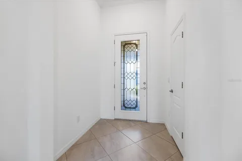 an empty room with cabinet and mirror