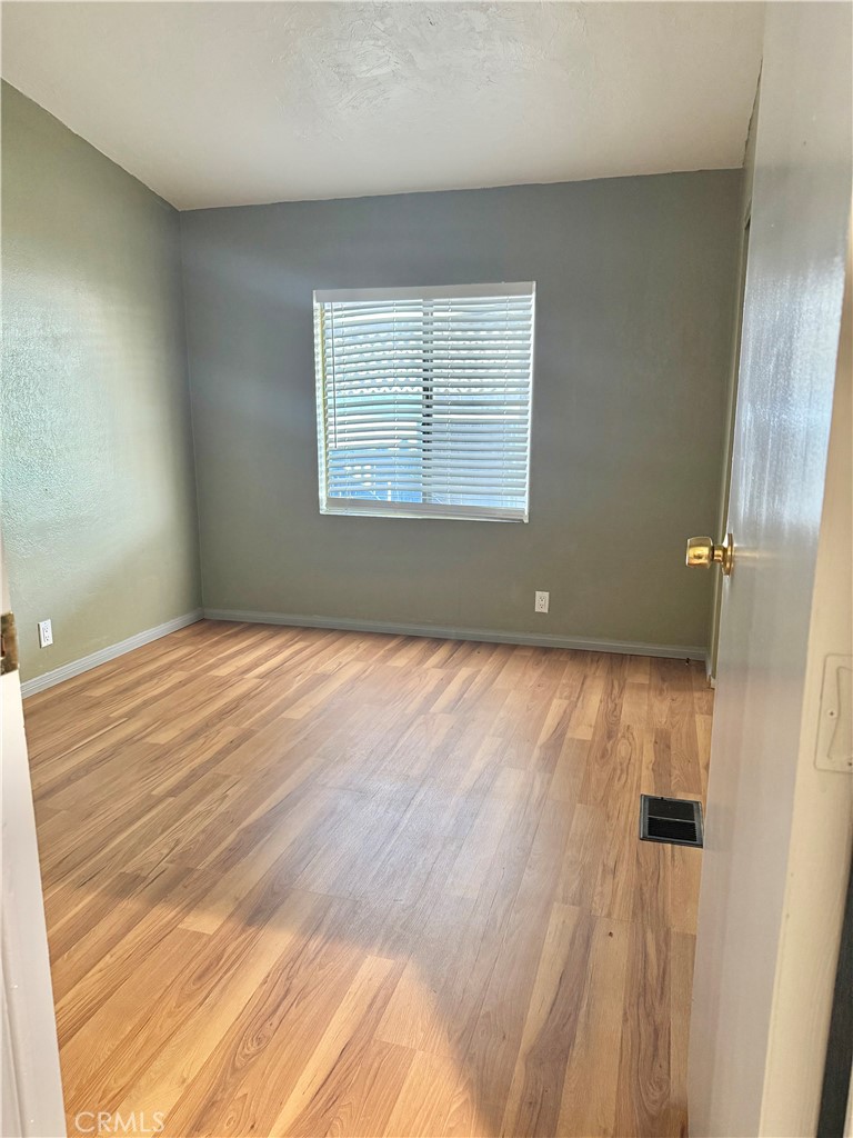 4080 Pedley Road, Unit 189 Jurupa Valley, CA 92509 - Photo 8 of 16 a view of an empty room with wooden floor and a window