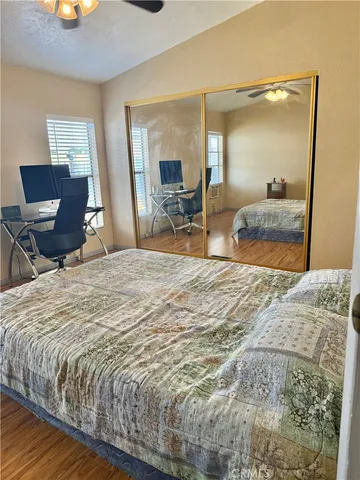 a bedroom with a bed and mirror