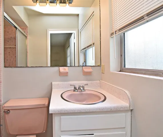 an empty room with a chandelier fan