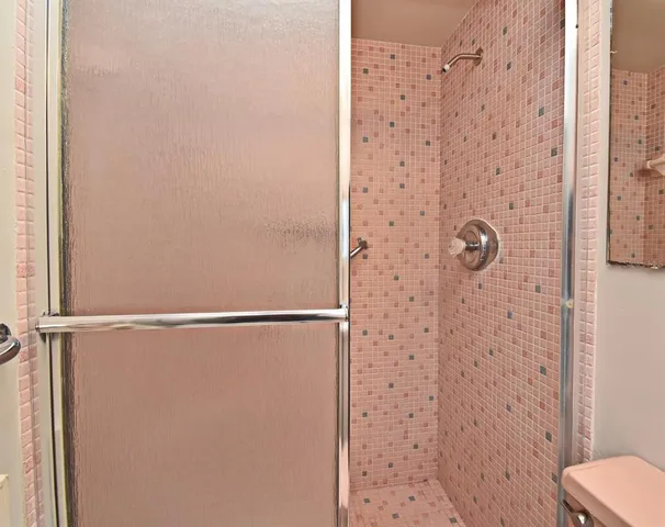 en empty room with windows and chandelier fan