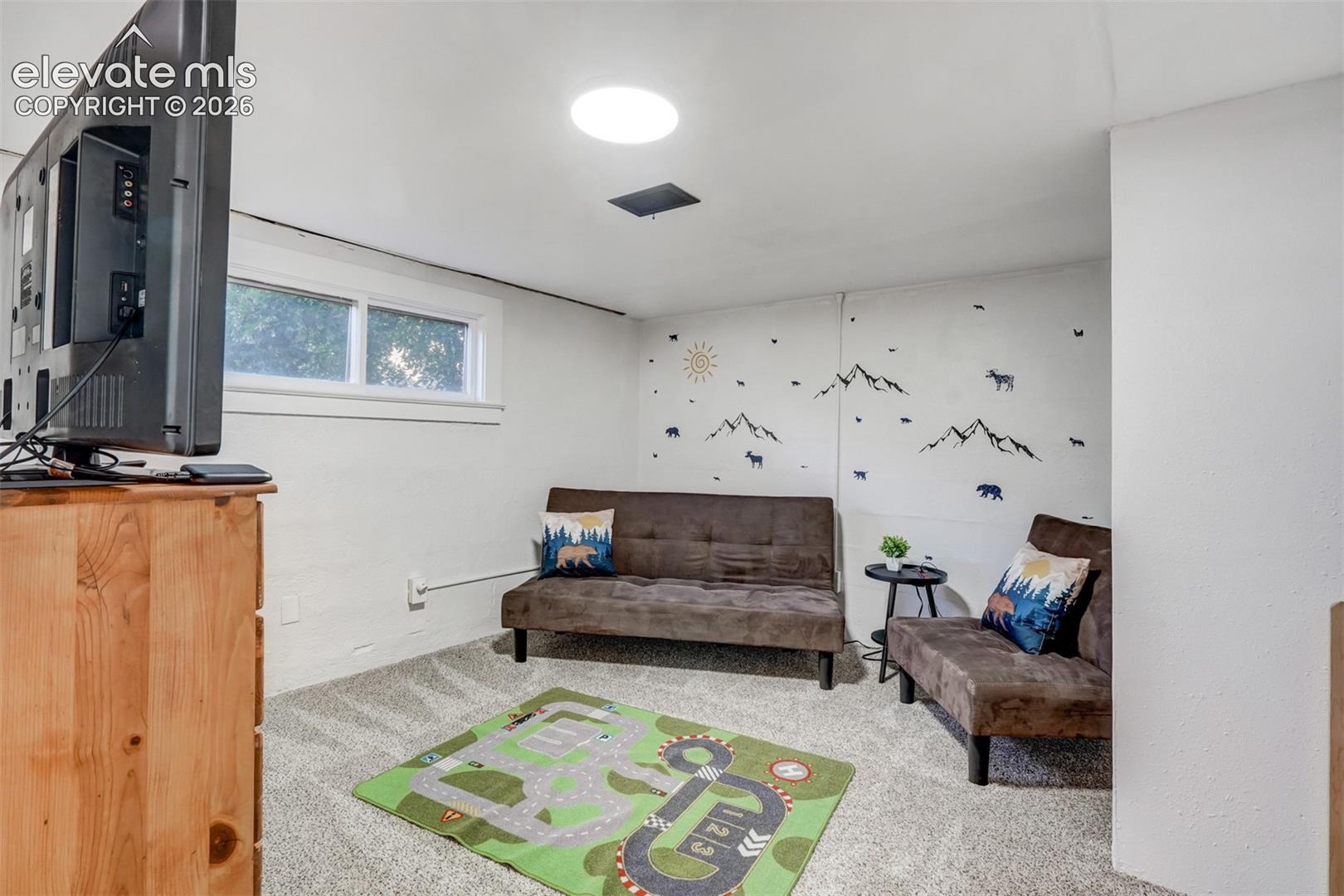 9955 Mesa Road Cascade, CO 80809 - Photo 39 of 41 Recessed lighting, wall-to-wall carpeting, and a window for natural light